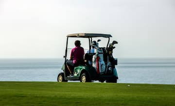 a group of people on a golf cart