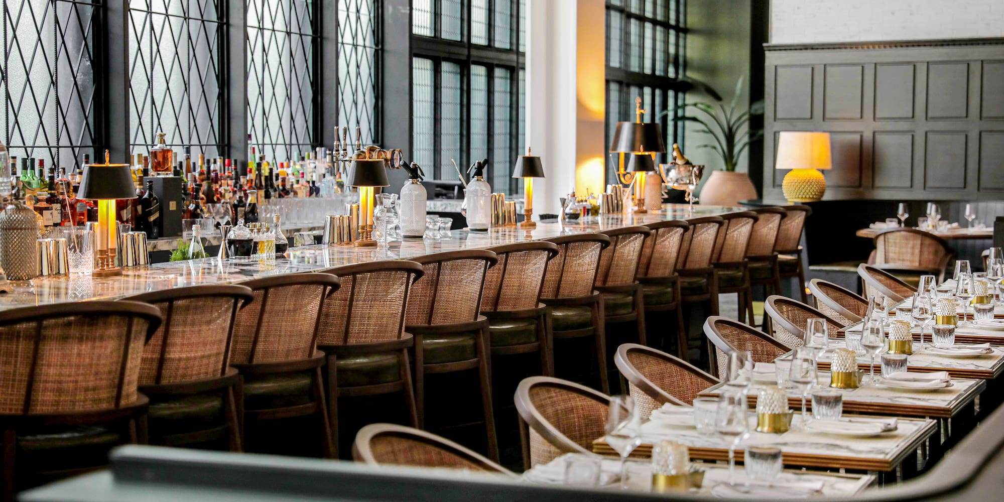 a long table with chairs and glasses