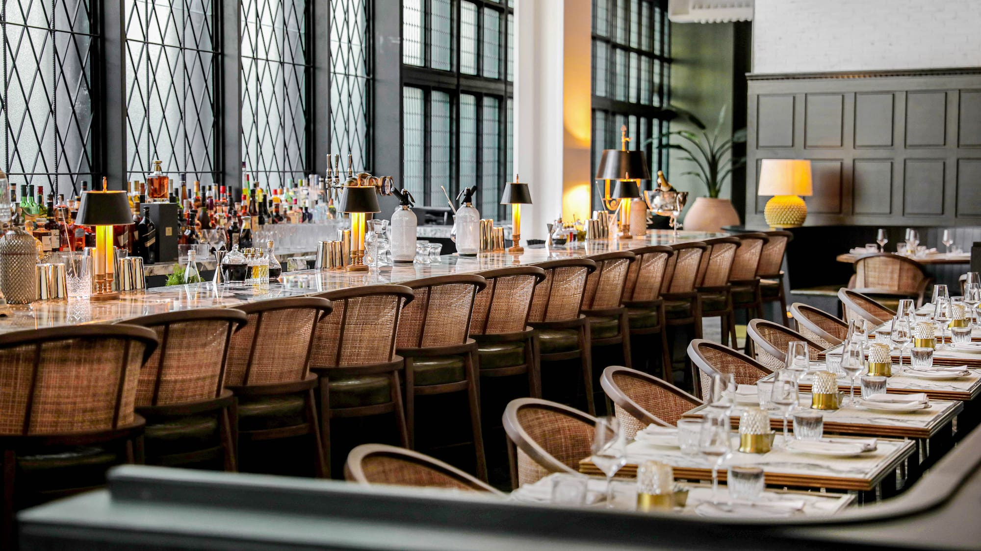 a long table with chairs and glasses