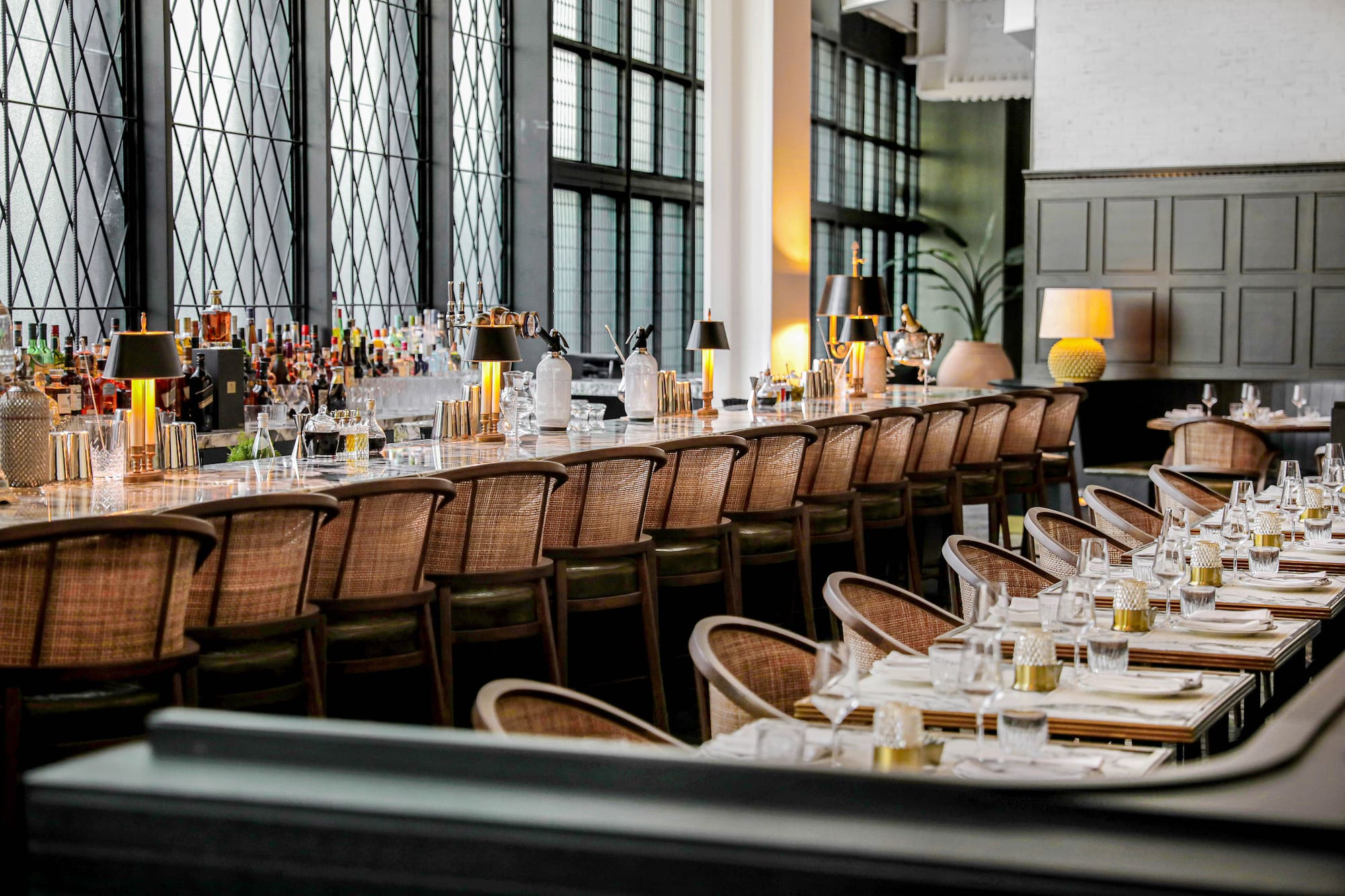 a long table with chairs and glasses