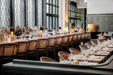 a long table with chairs and glasses