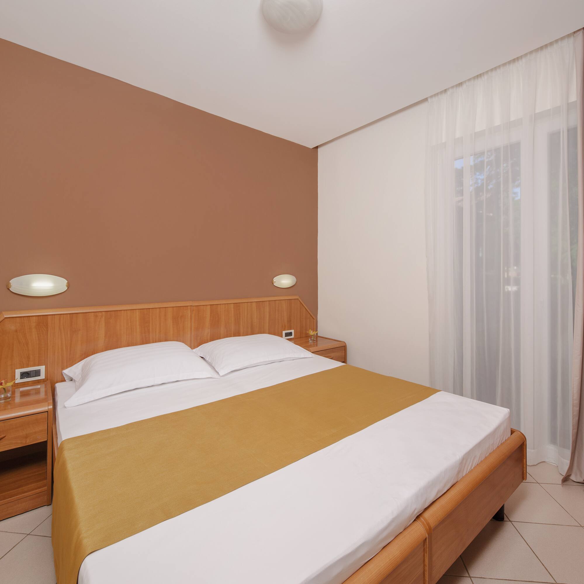 a bed with a wood headboard and a wood headboard