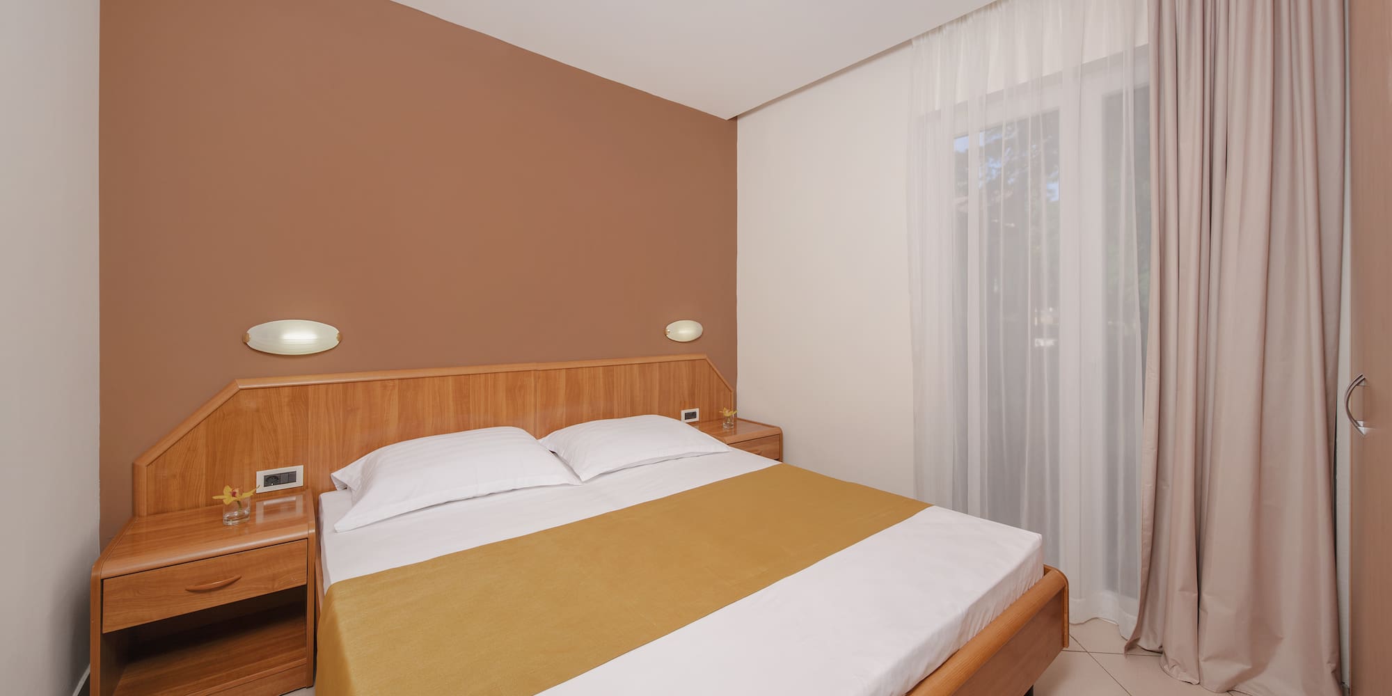 a bed with a wood headboard and a wood headboard