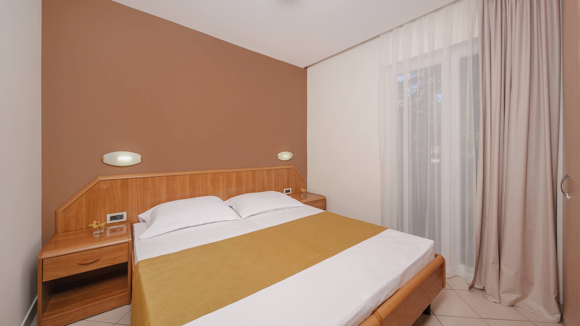 a bed with a wood headboard and a wood headboard