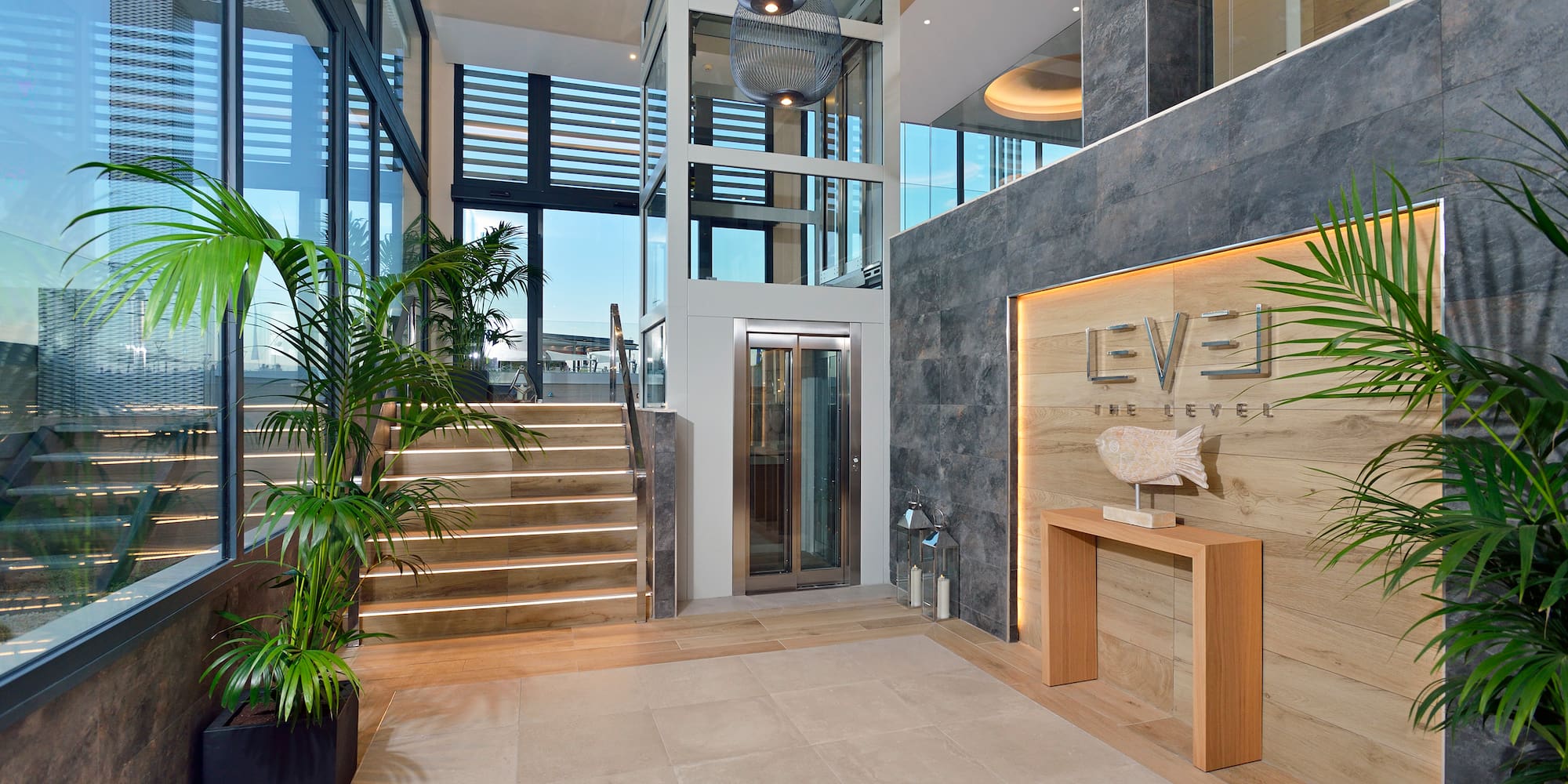 a lobby with a staircase and a sign