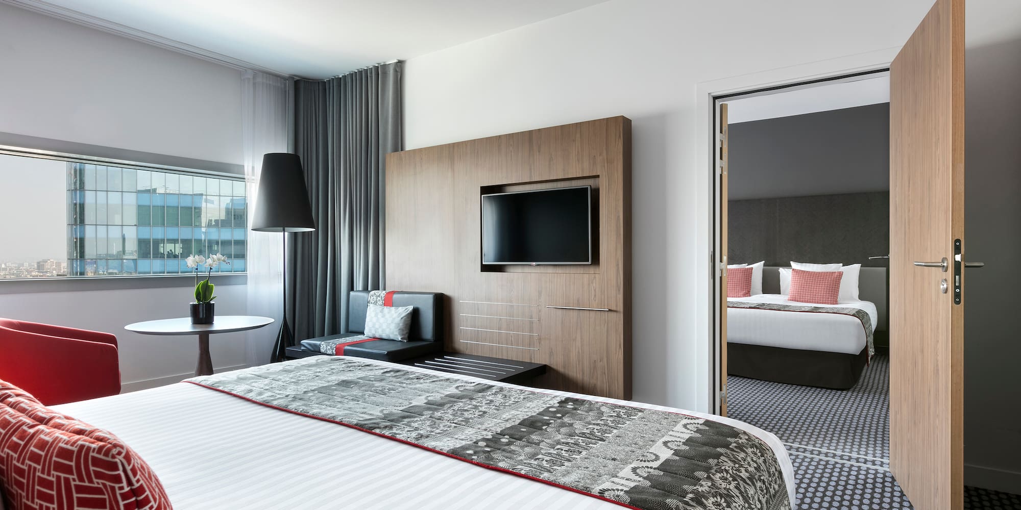 a room with a bed and a television