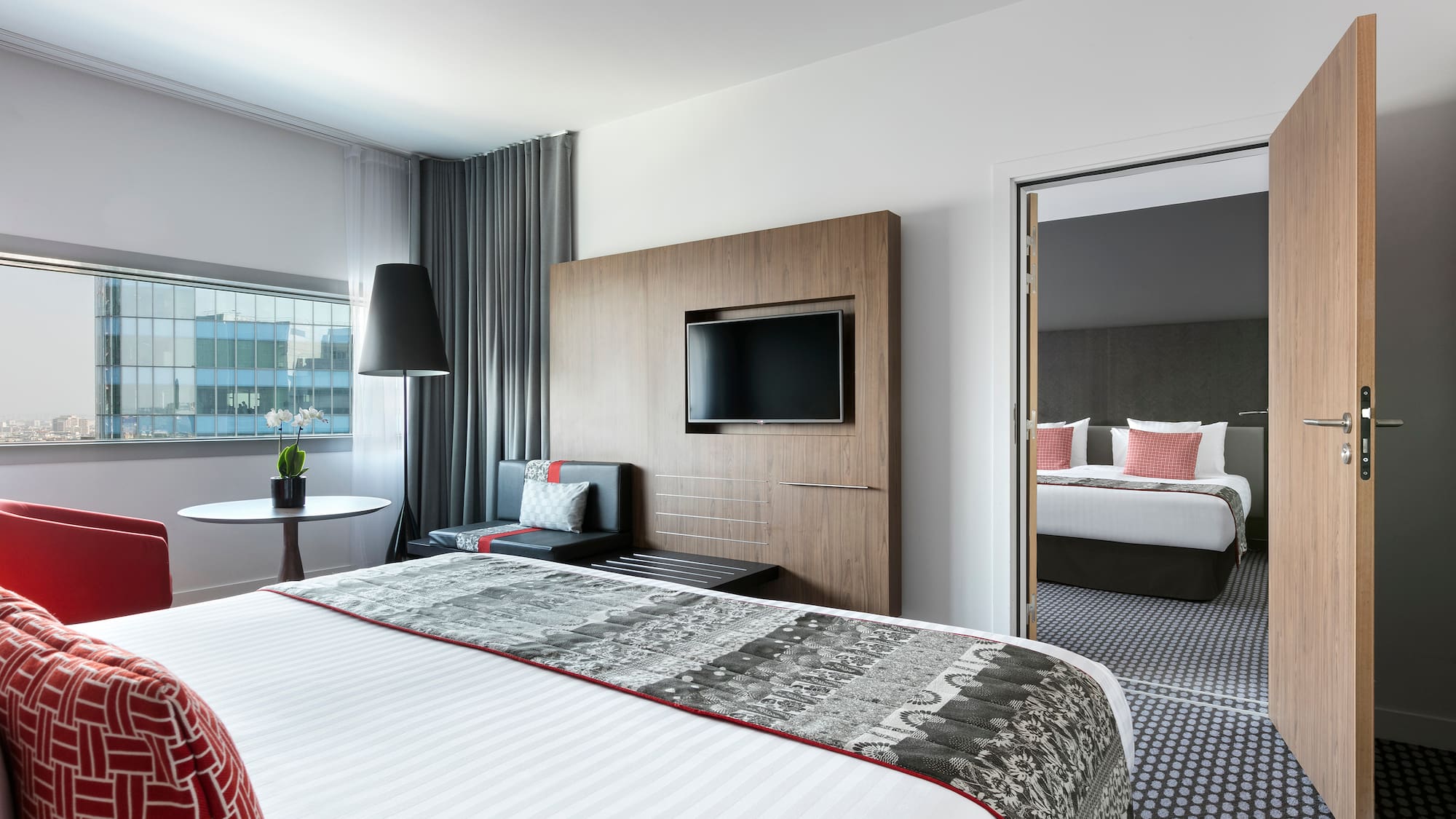 a room with a bed and a television