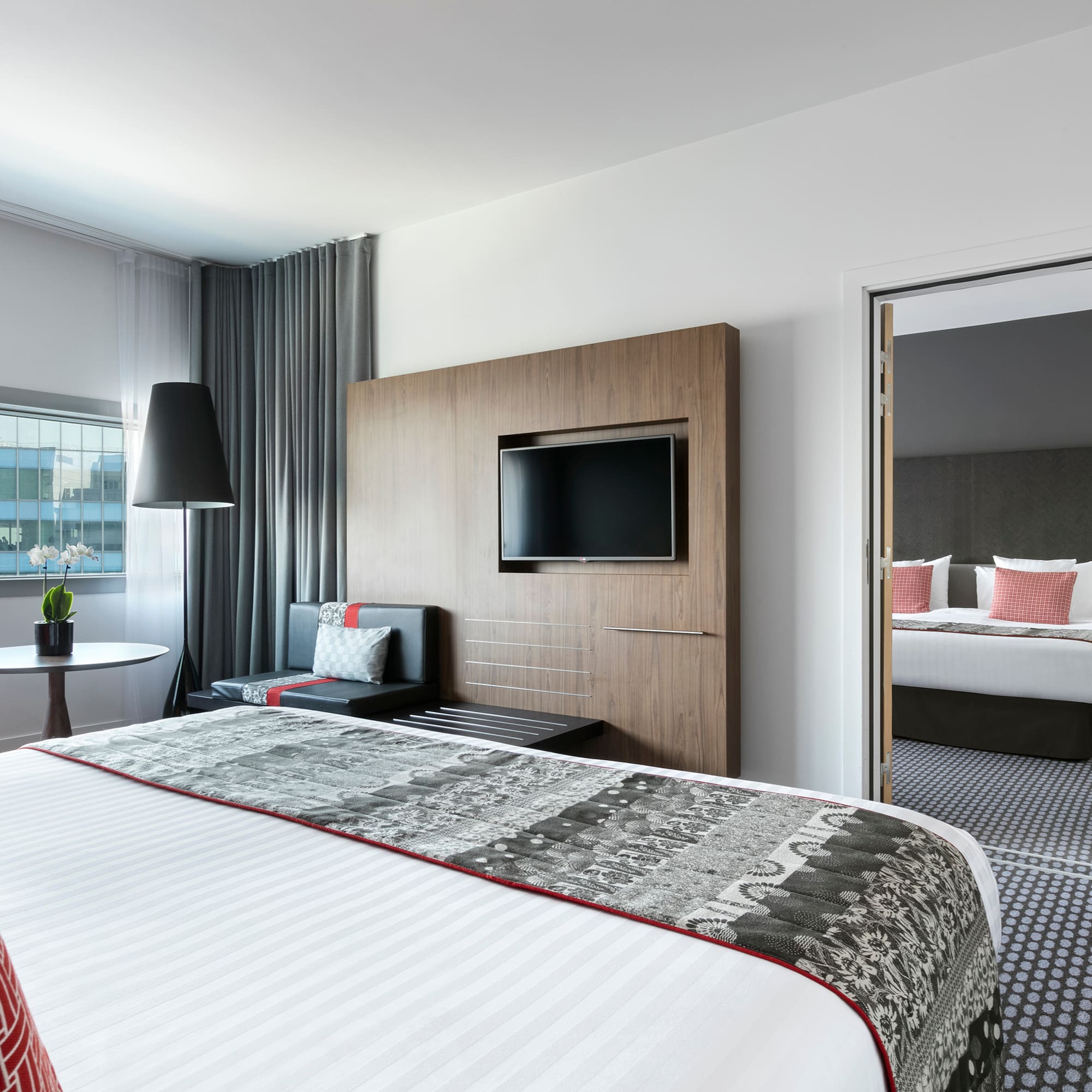 a room with a bed and a television