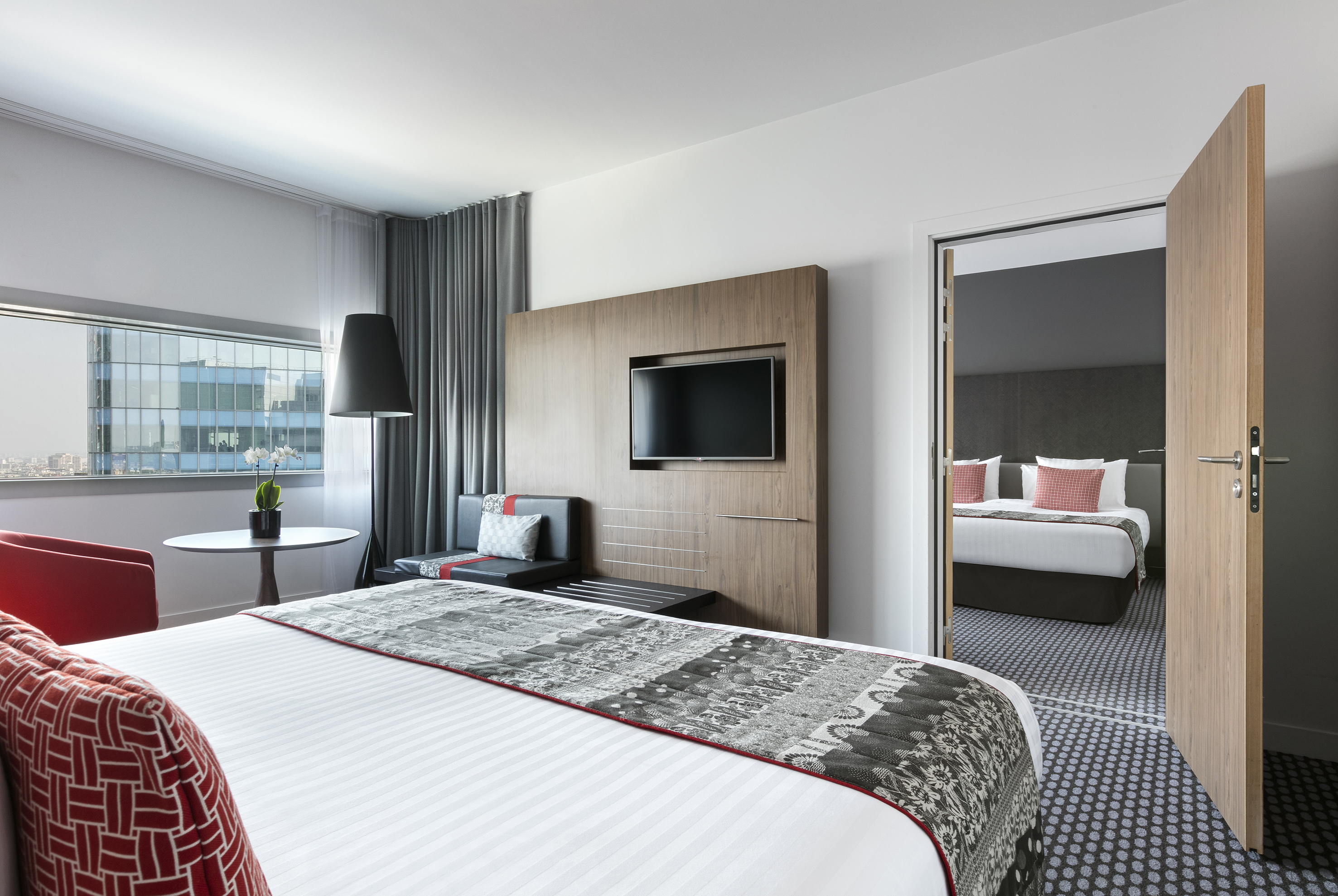 a room with a bed and a television