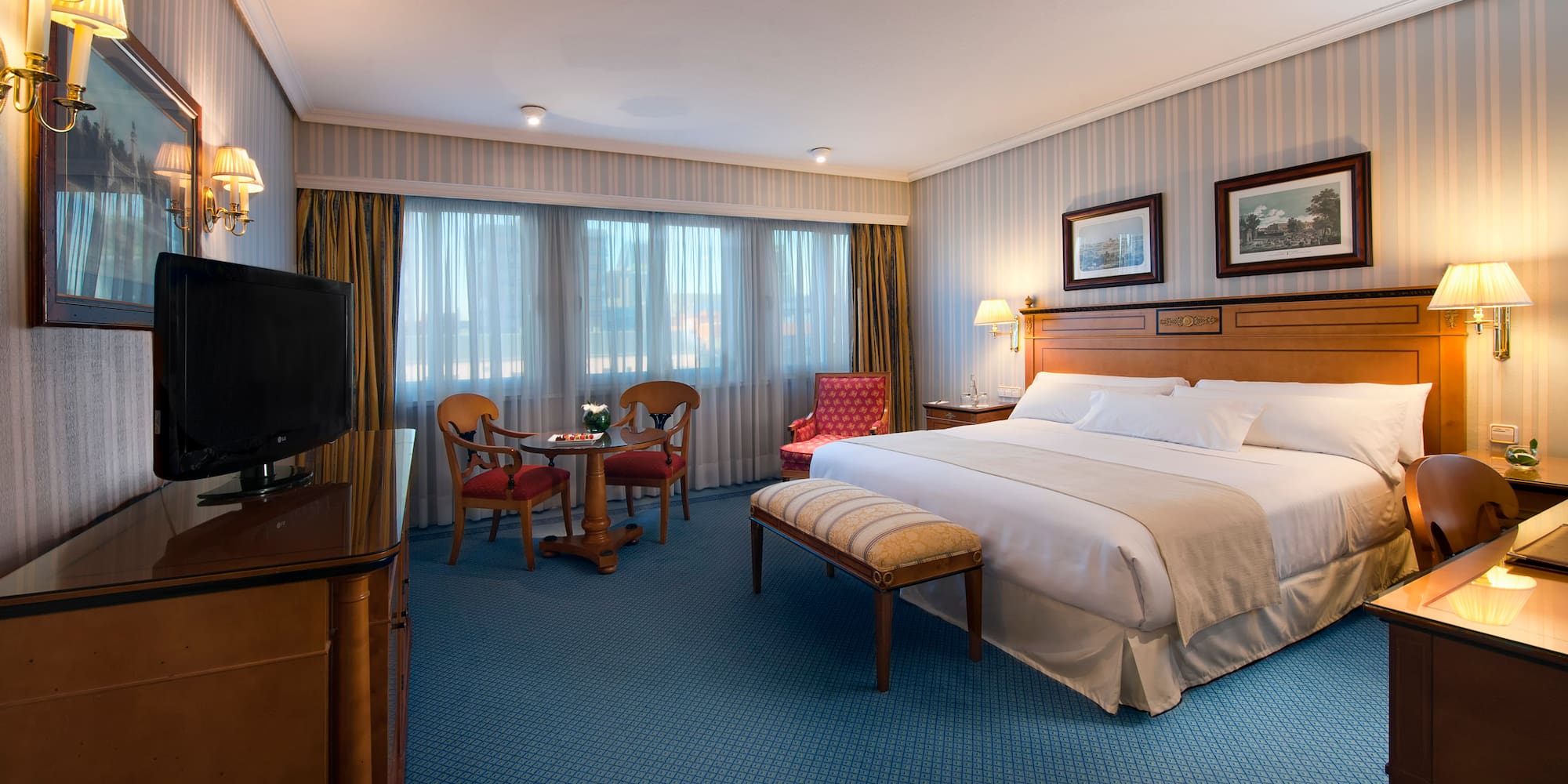 a room with a bed and a television