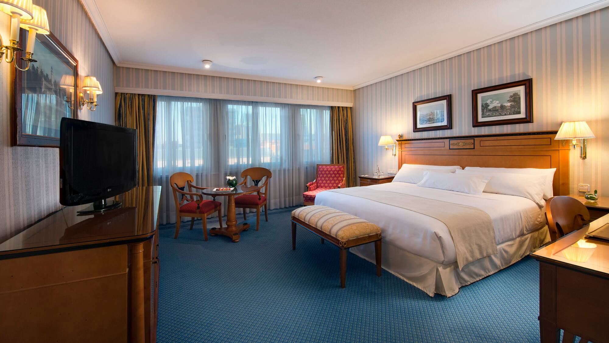 a room with a bed and a television