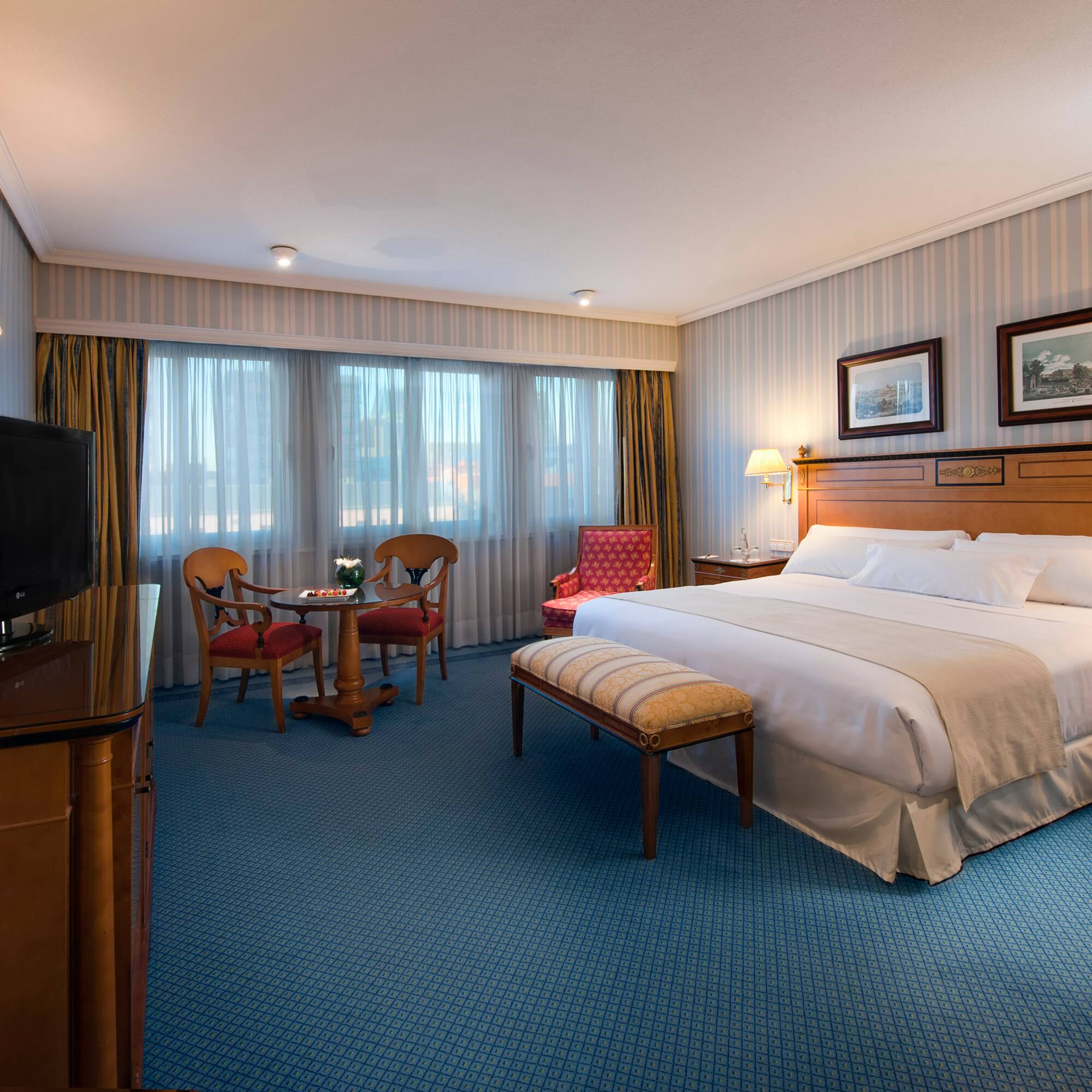 a room with a bed and a television