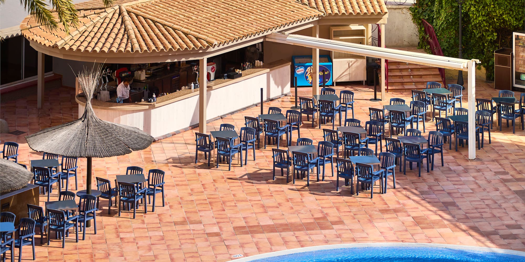 a pool with tables and chairs