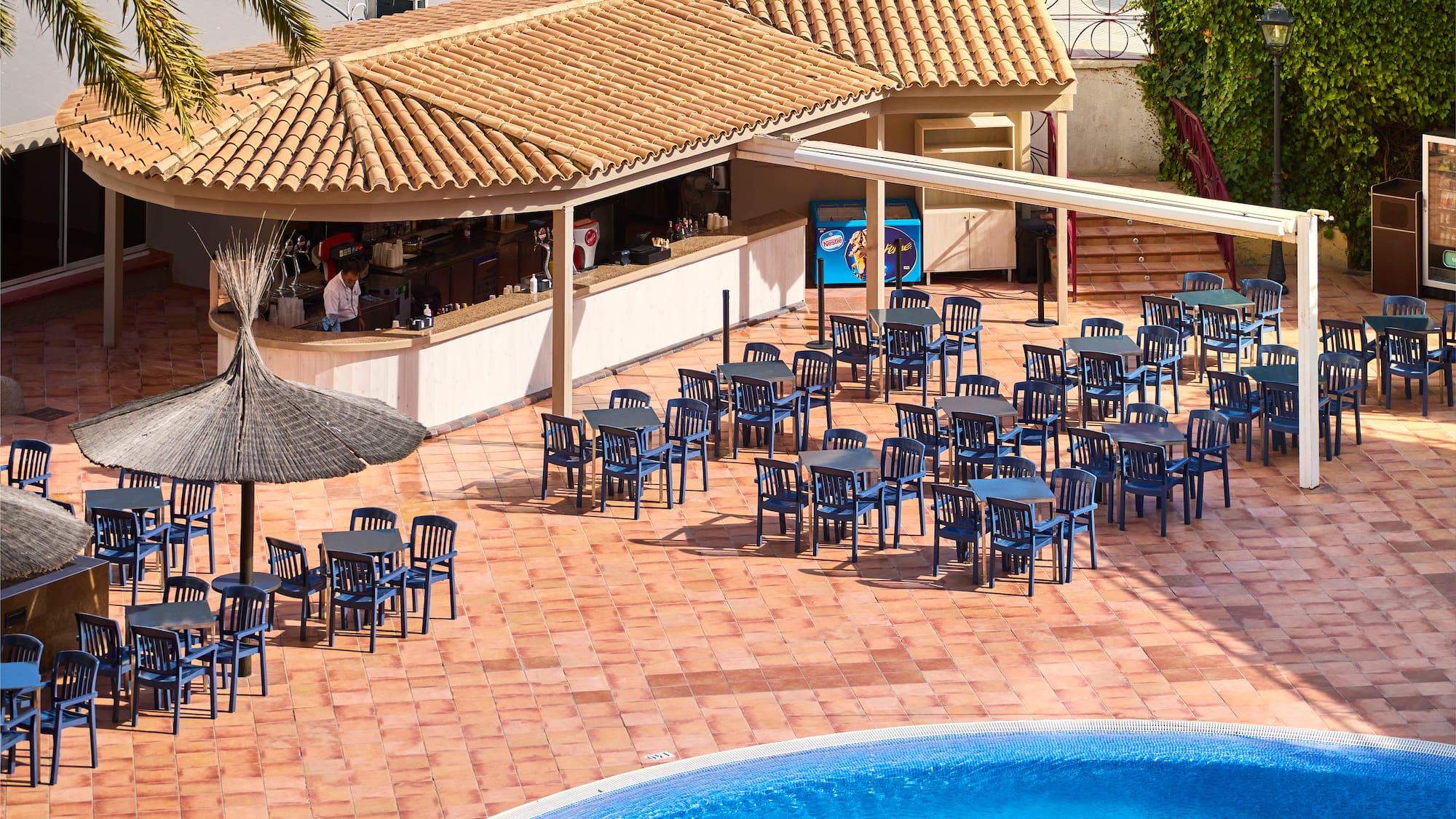 a pool with tables and chairs