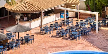 a pool with tables and chairs