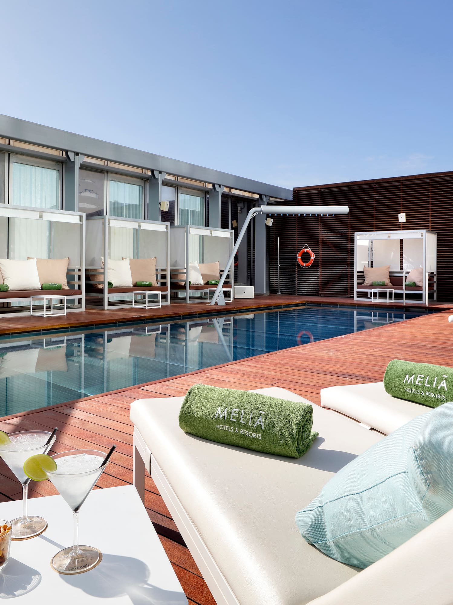 a pool with drinks and lounge chairs