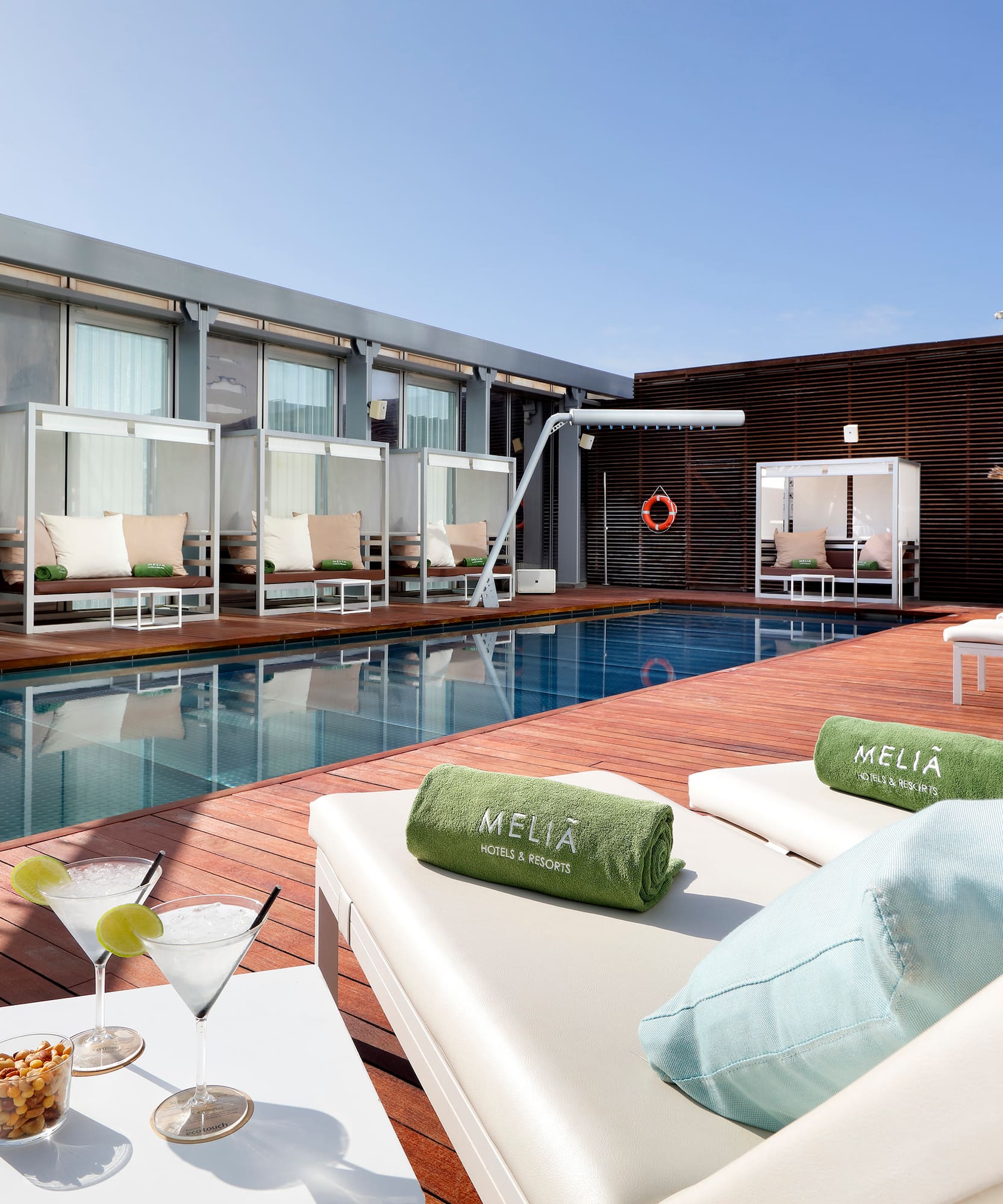 a pool with drinks and lounge chairs