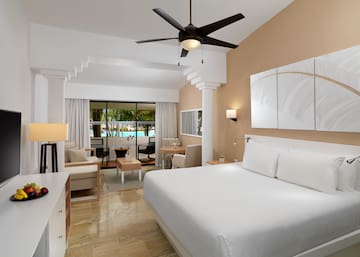 a room with a bed and a ceiling fan