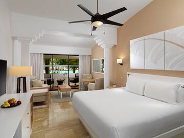 a room with a bed and a ceiling fan