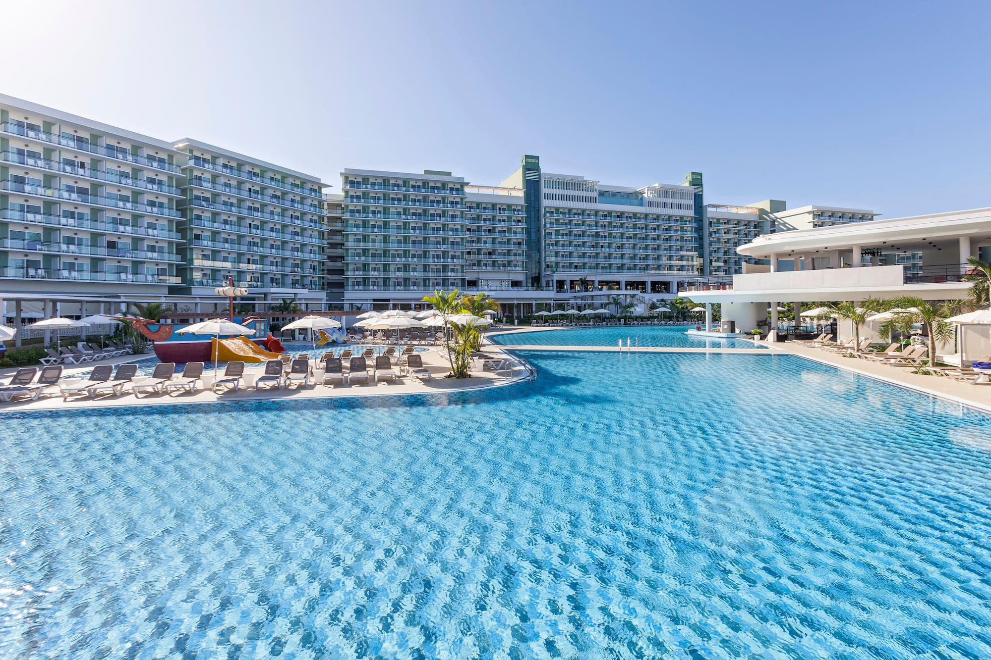 a swimming pool with a large building in the background