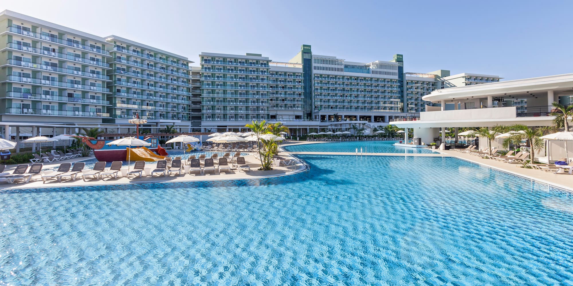 a swimming pool with a large building in the background