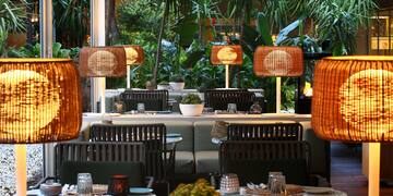 a table and chairs with lamps