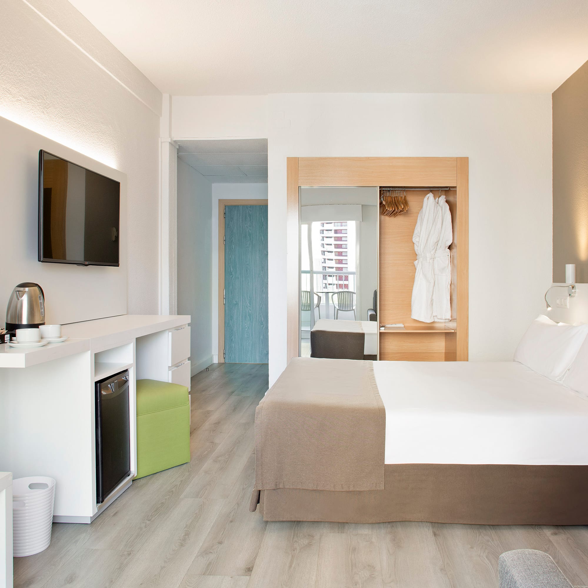 a room with a bed and a television