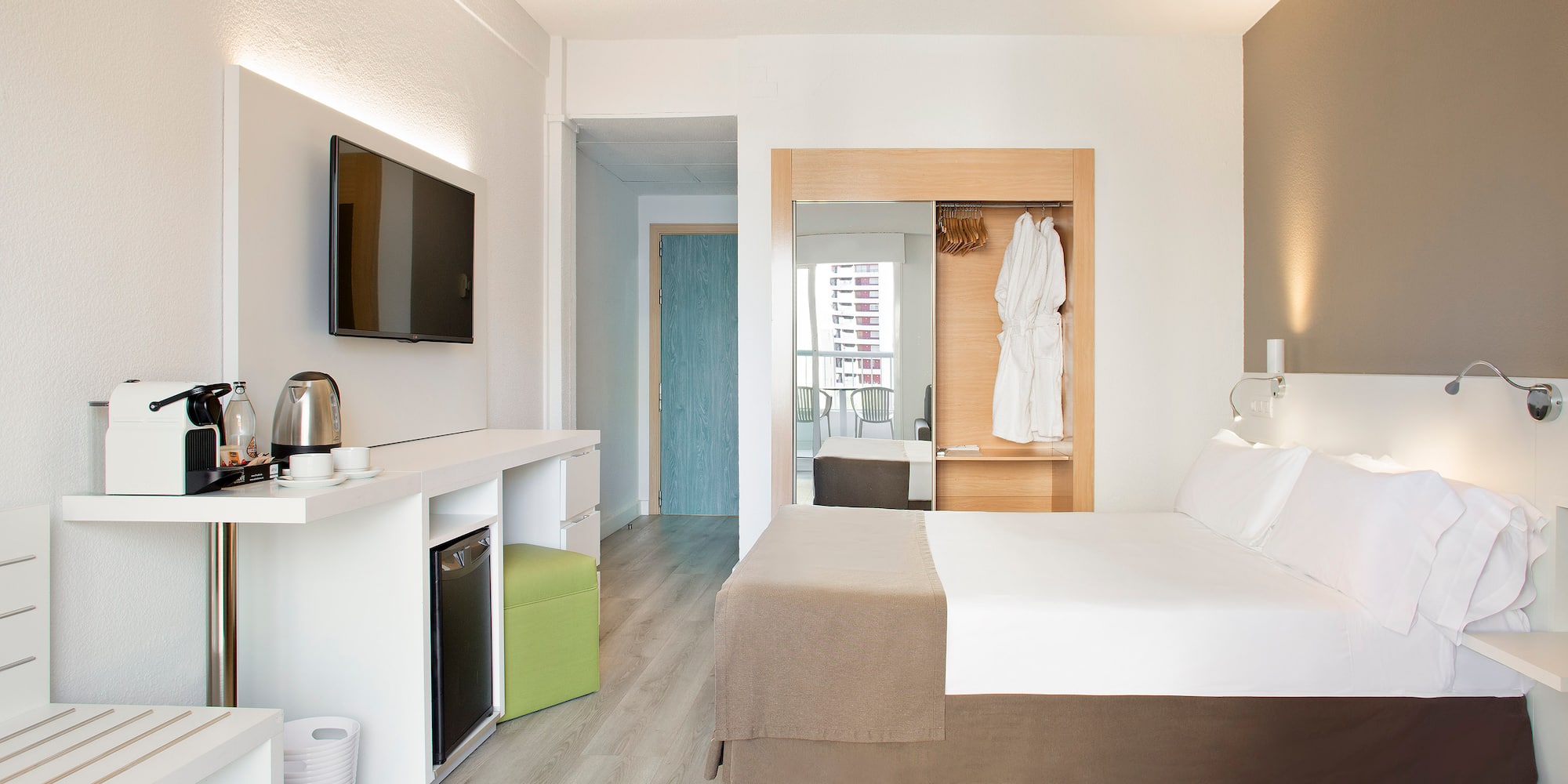 a room with a bed and a television