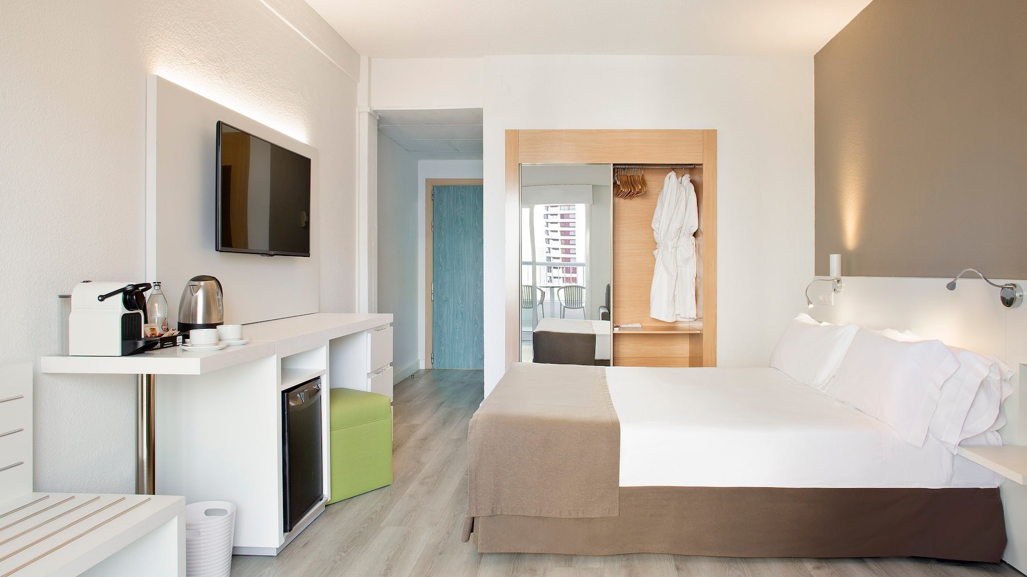 a room with a bed and a television