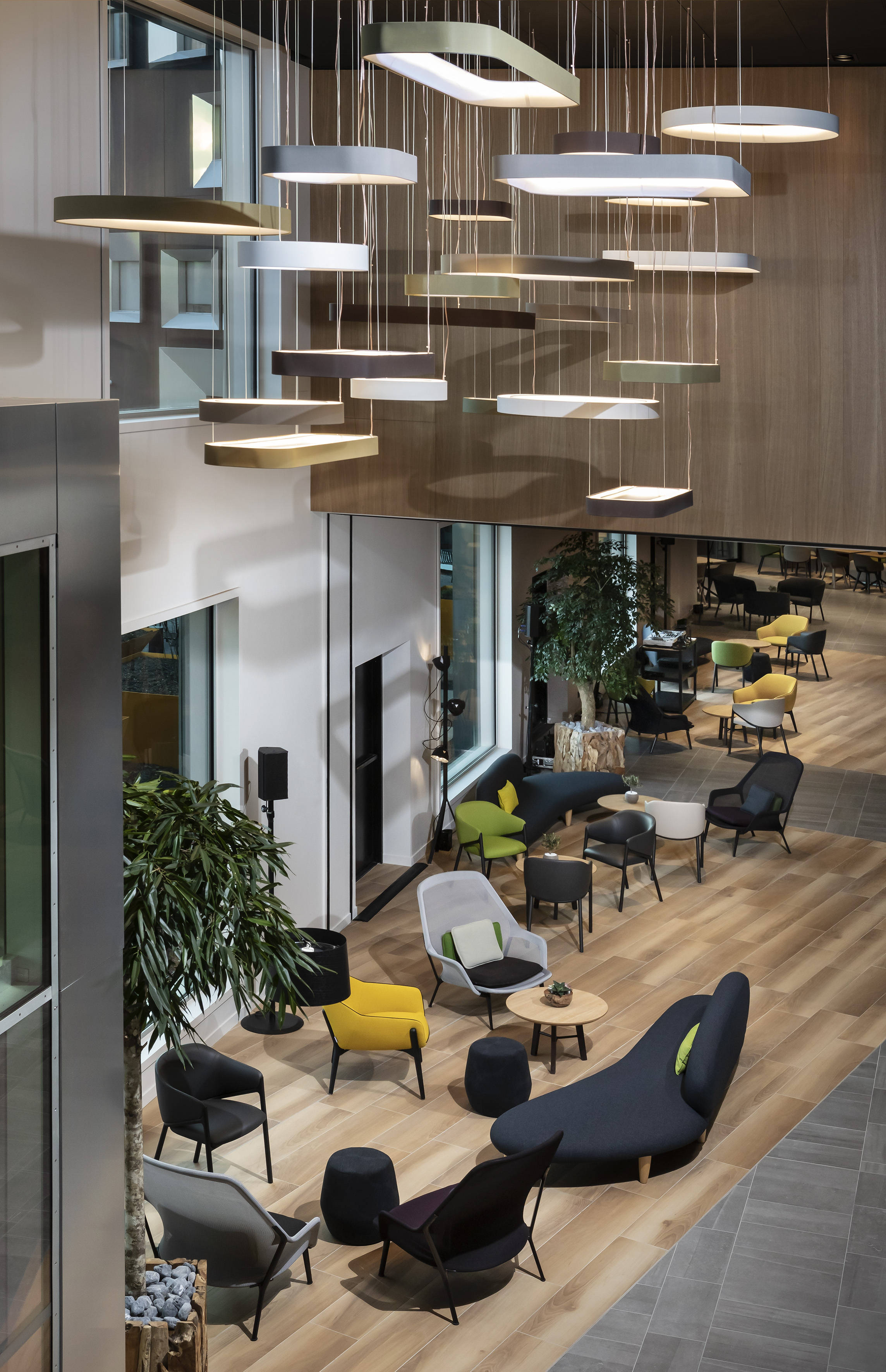Modern lobby with stylish pendant lighting and colorful lounge seating.