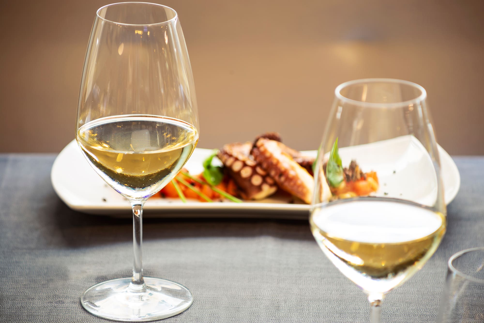 a glass of wine next to a plate of food