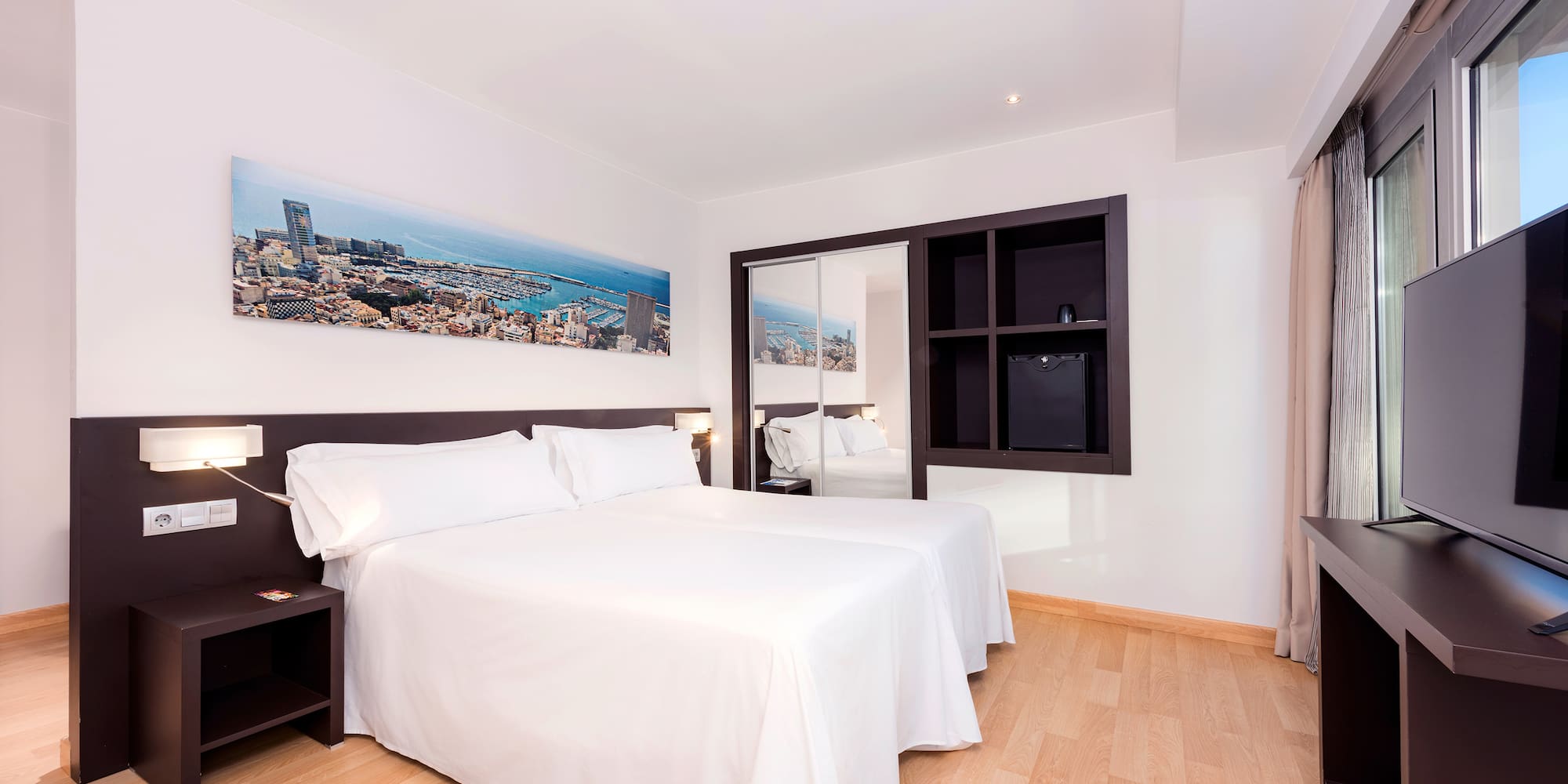 a room with a bed and a mirror