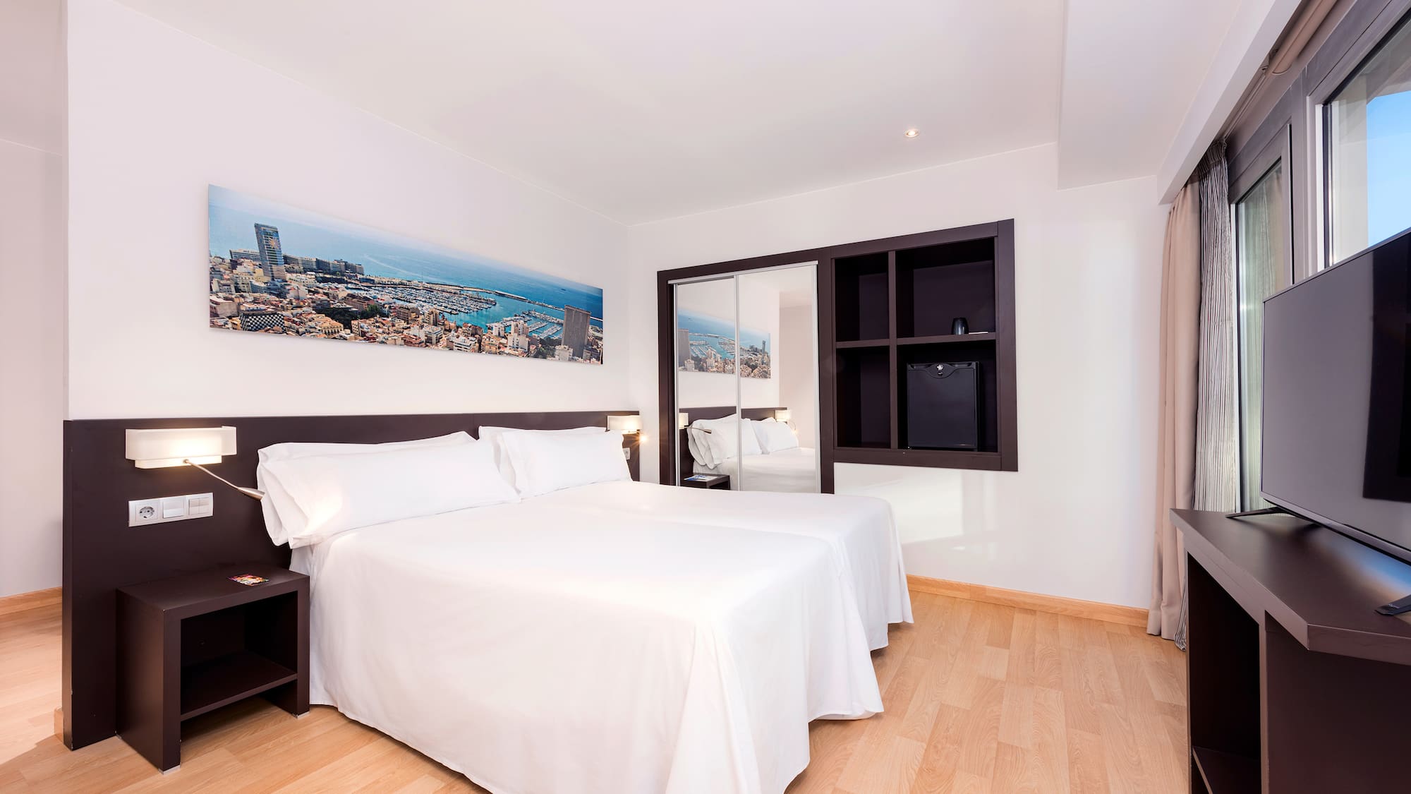 a room with a bed and a mirror