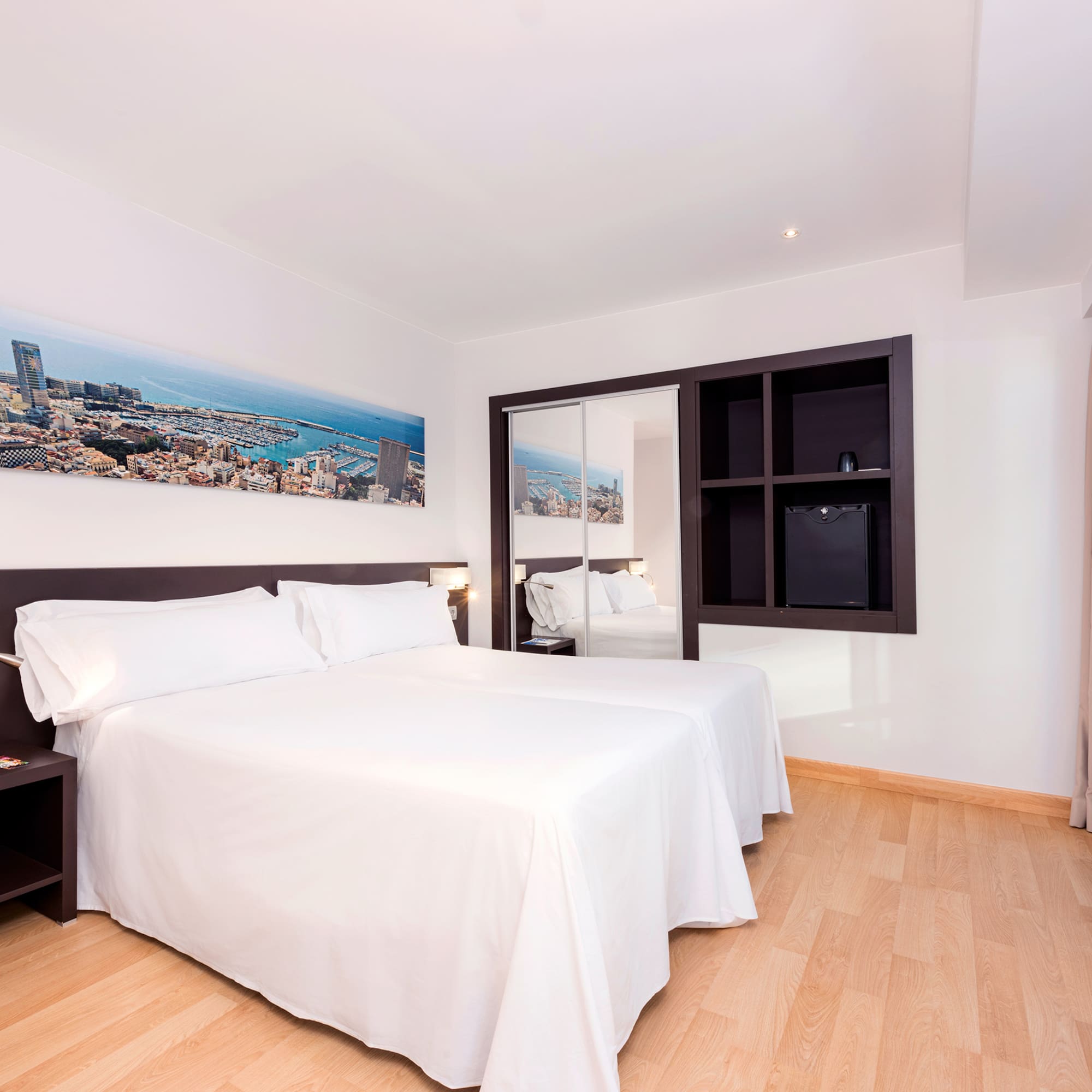 a room with a bed and a mirror