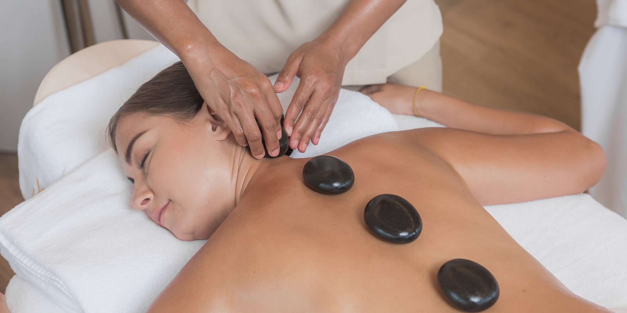 a woman lying down with a massage on her back