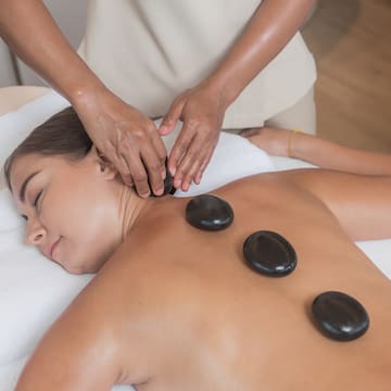 a woman lying down with a massage on her back