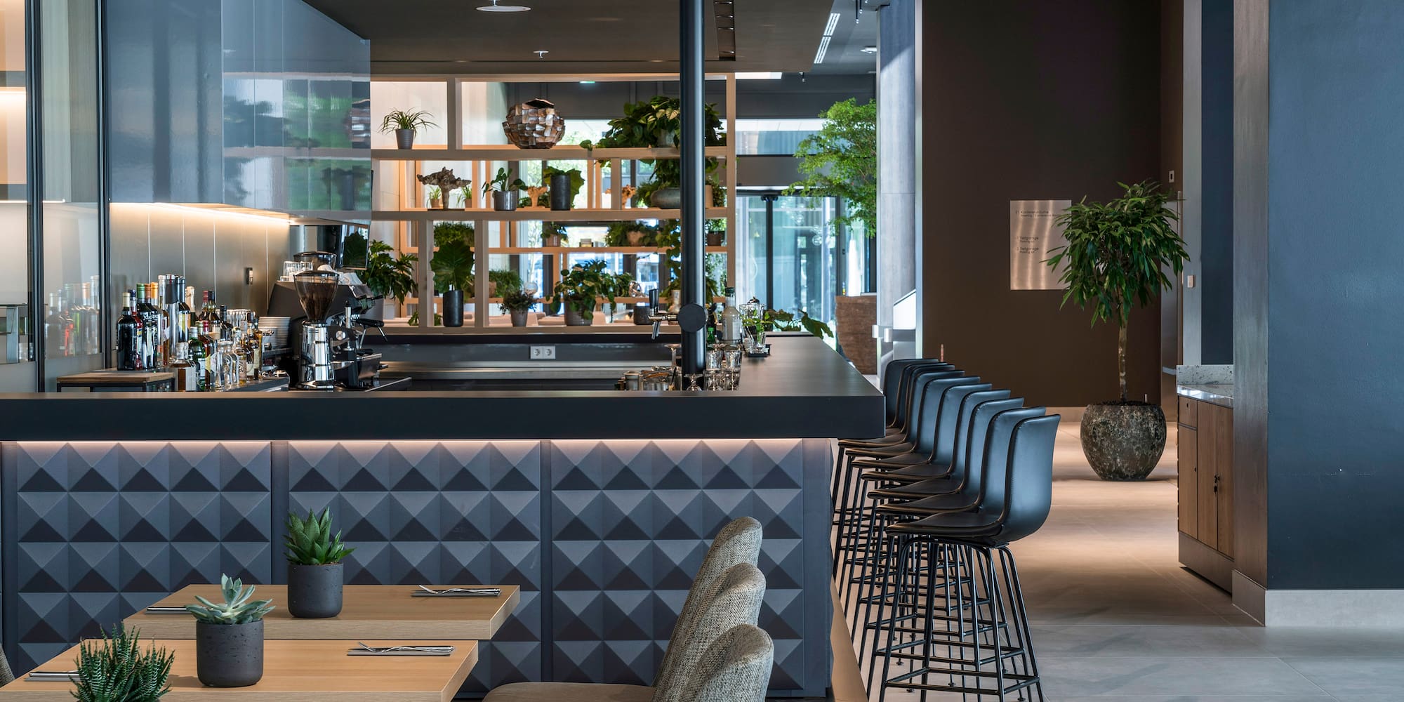 a room with a bar and chairs