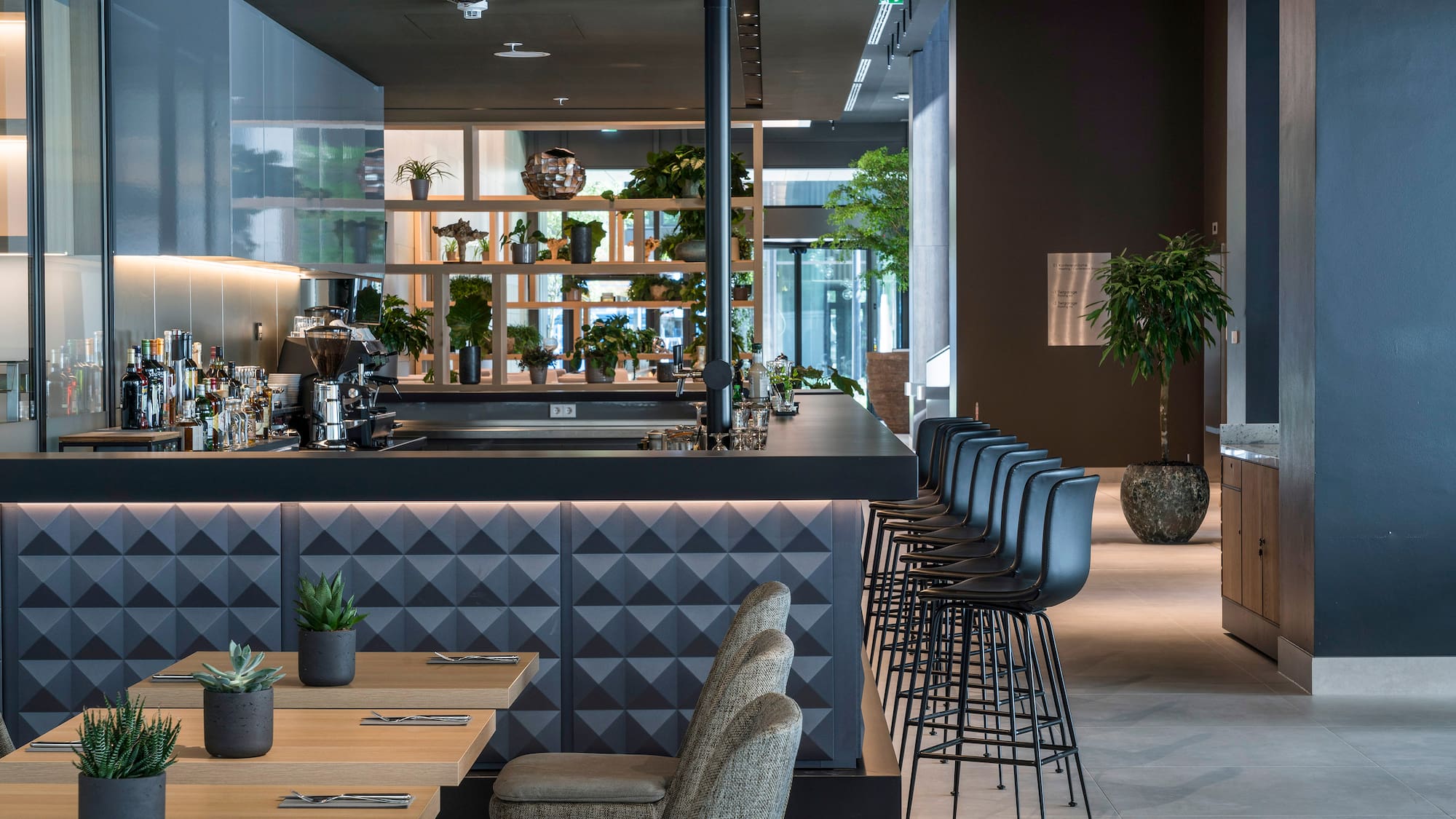 a room with a bar and chairs