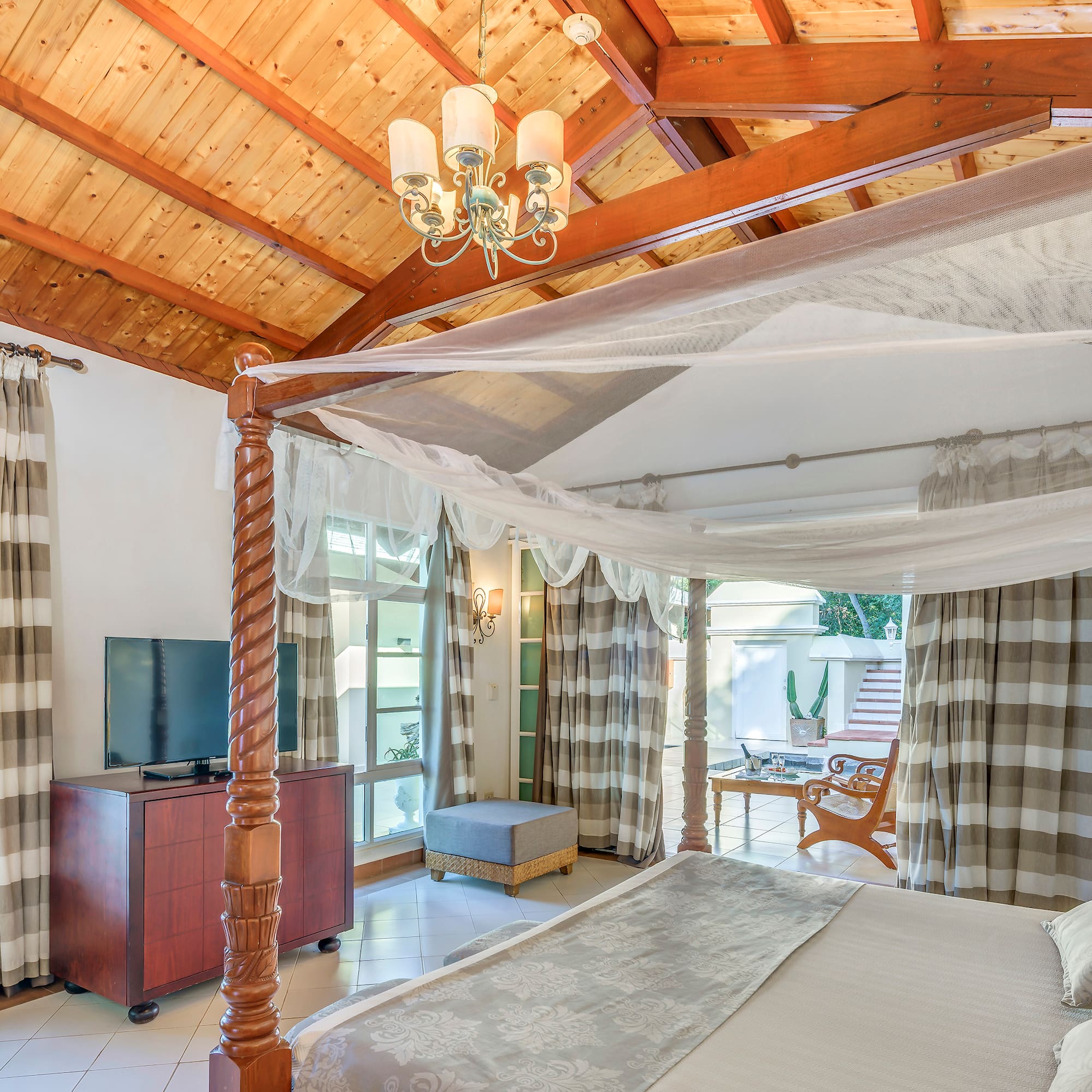 a room with a bed and a television