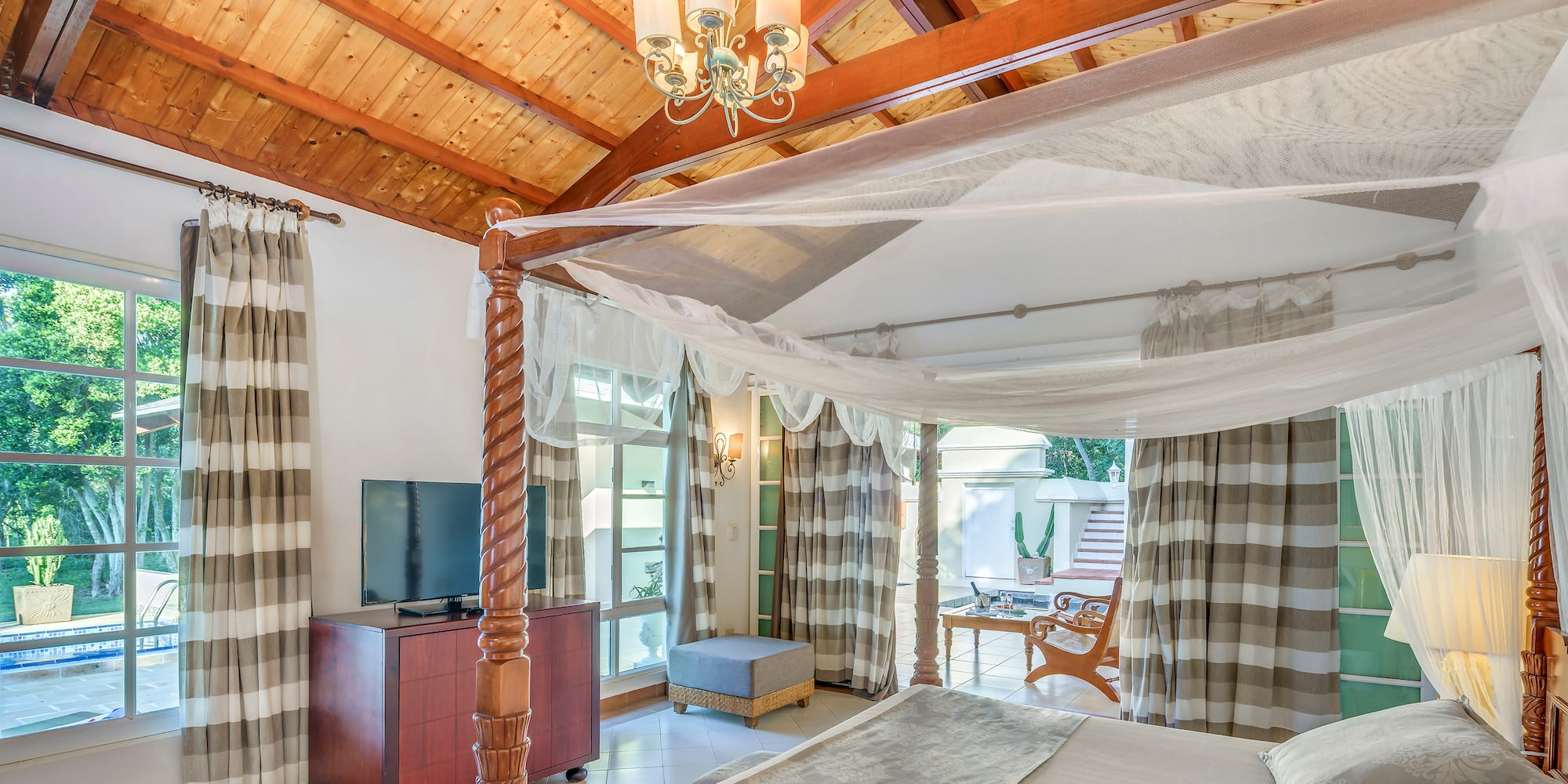 a room with a bed and a television