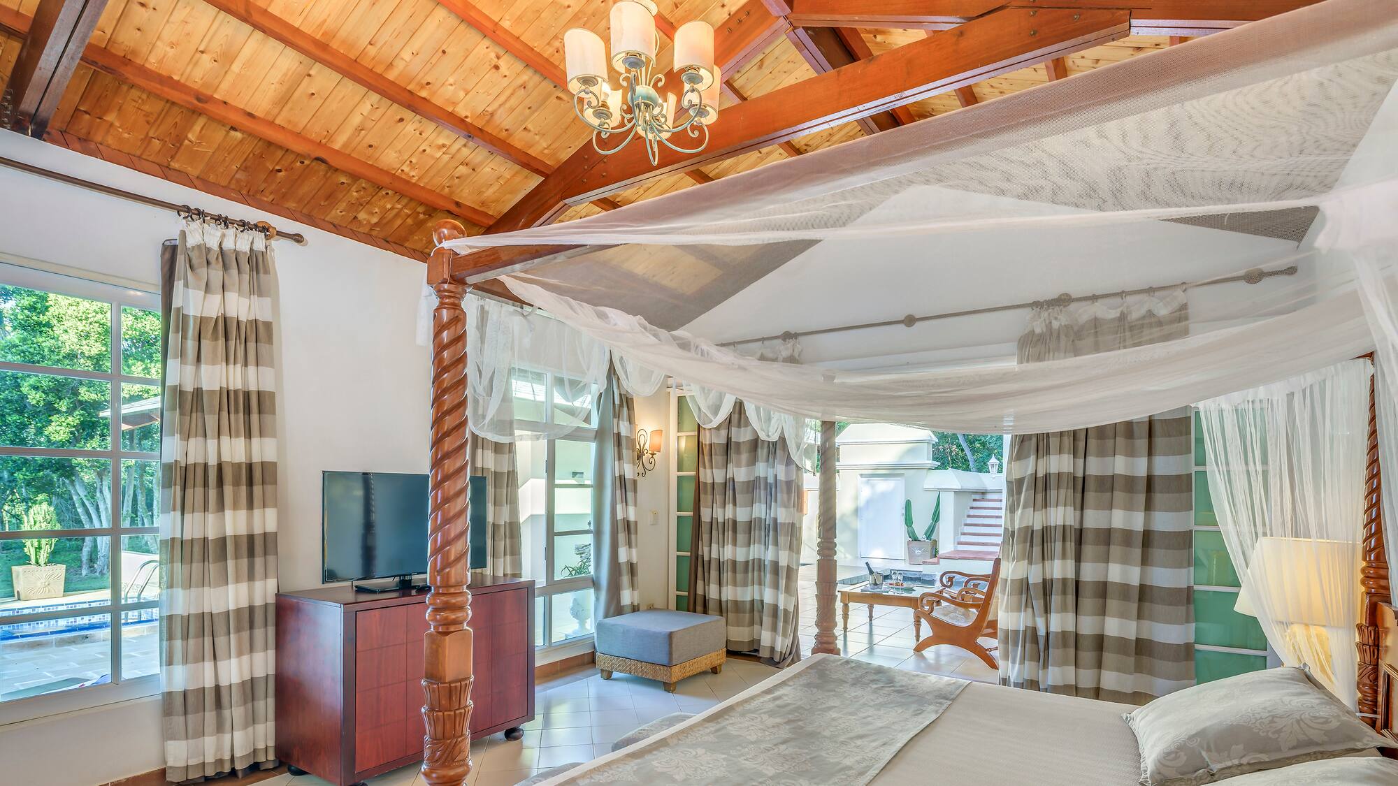 a room with a bed and a television