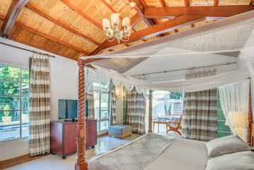 a room with a bed and a television