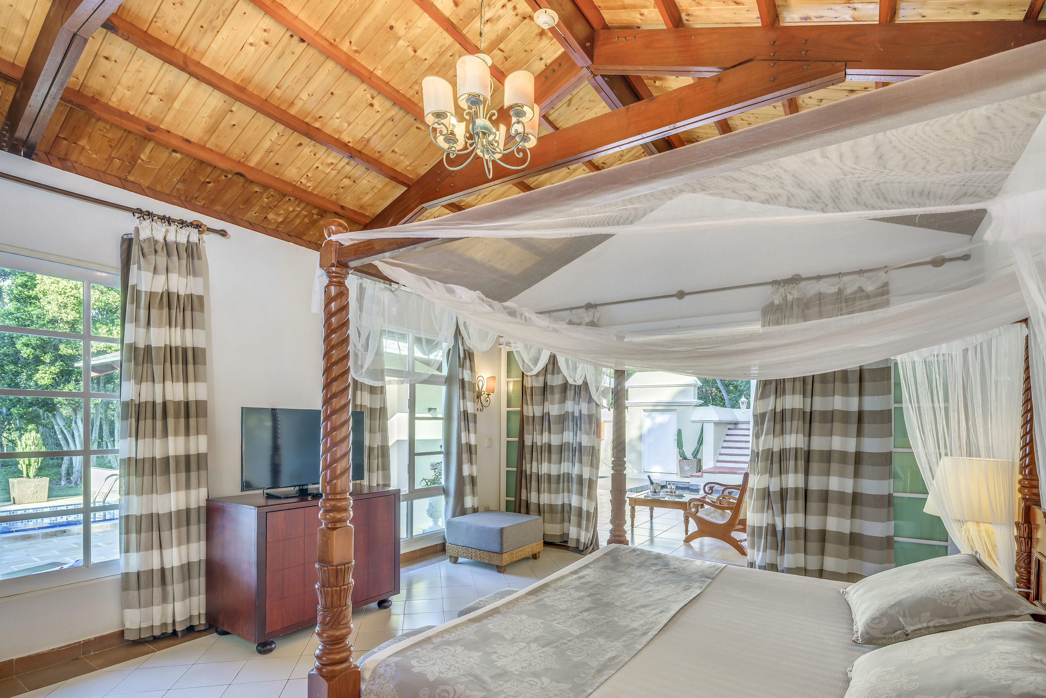 a room with a bed and a television