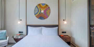 a bed with a colorful circle on the wall