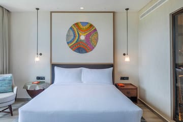 a bed with a colorful circle on the wall