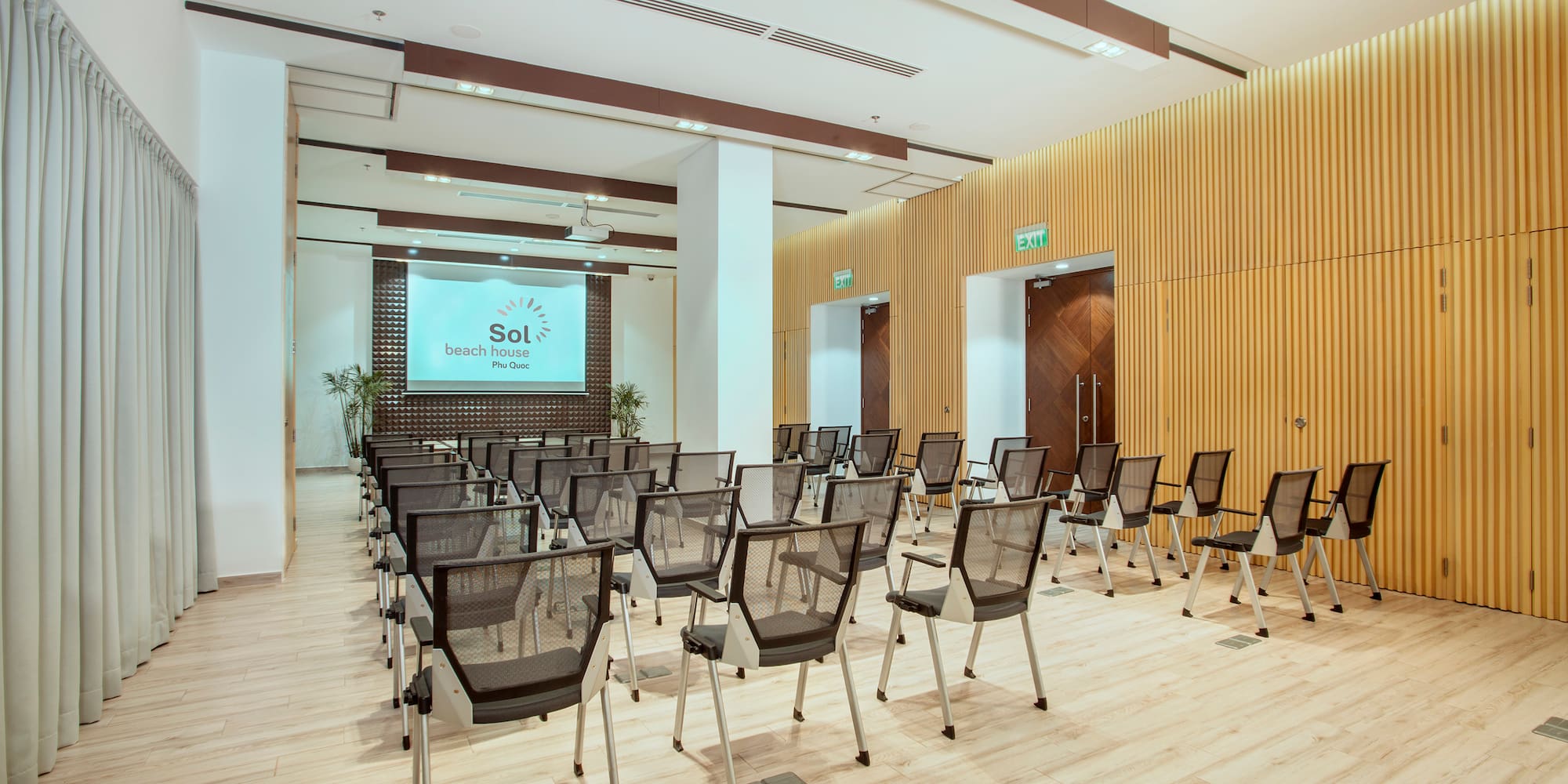 a room with chairs and a screen