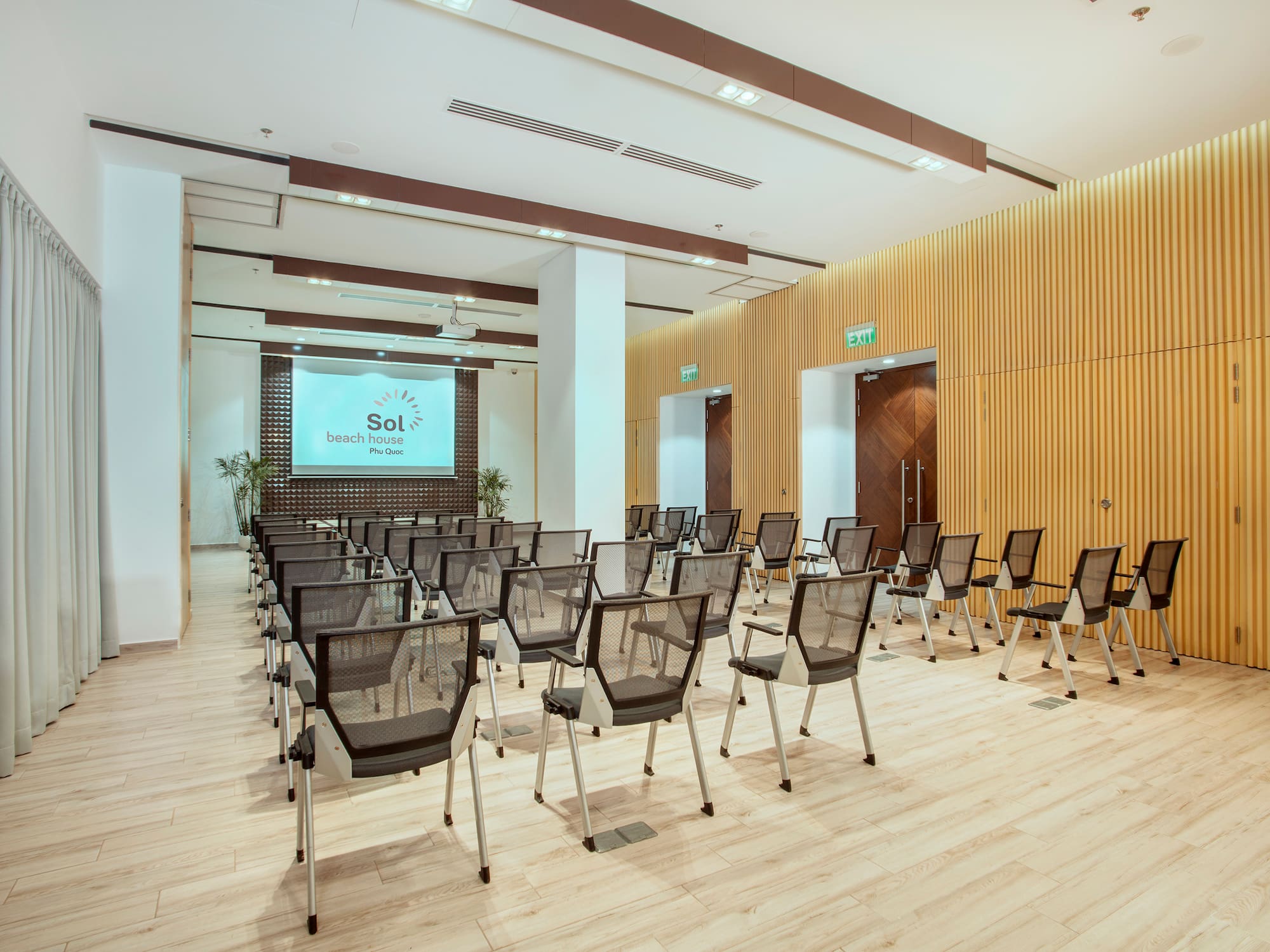 a room with chairs and a screen