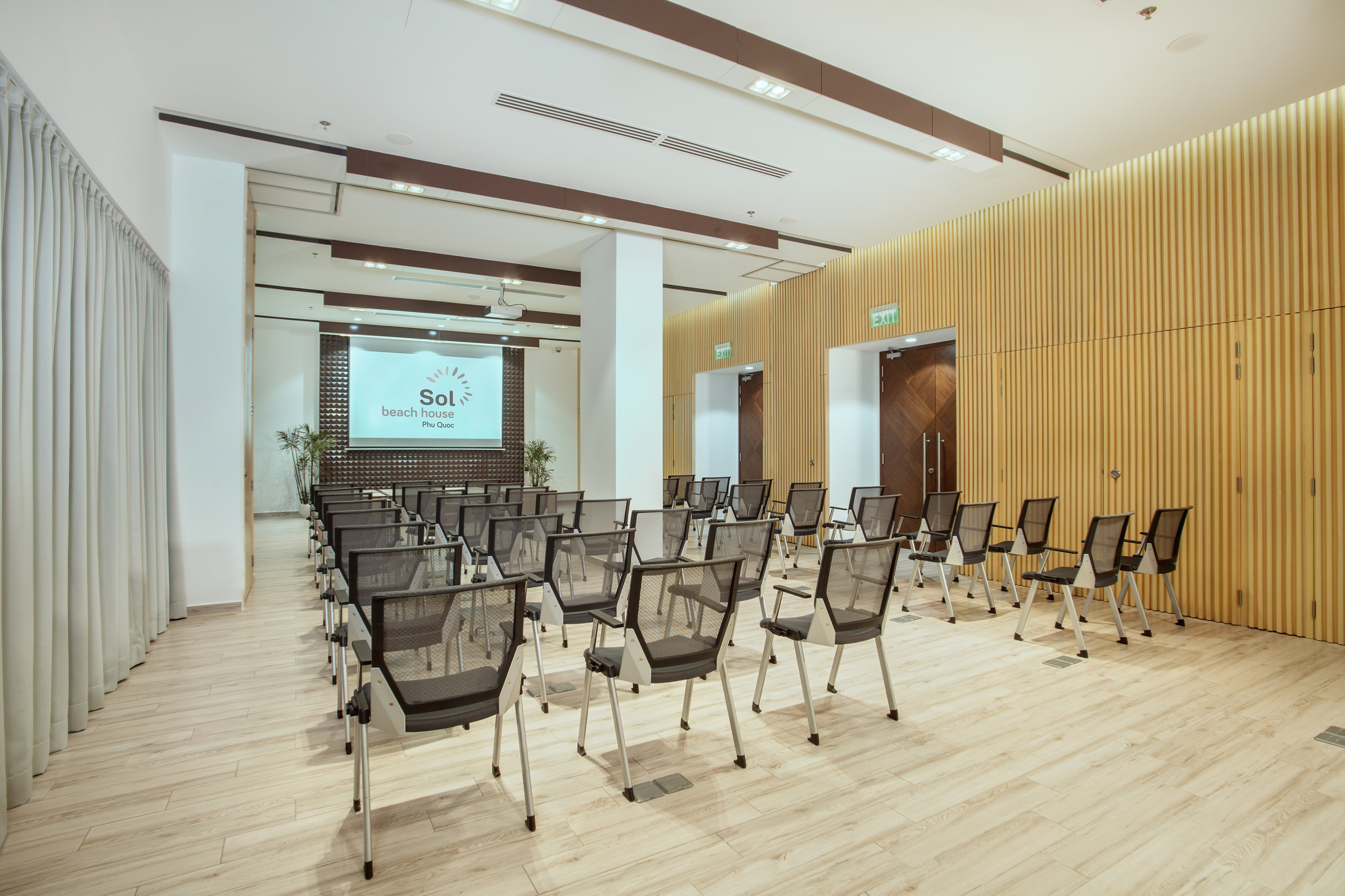 a room with chairs and a screen