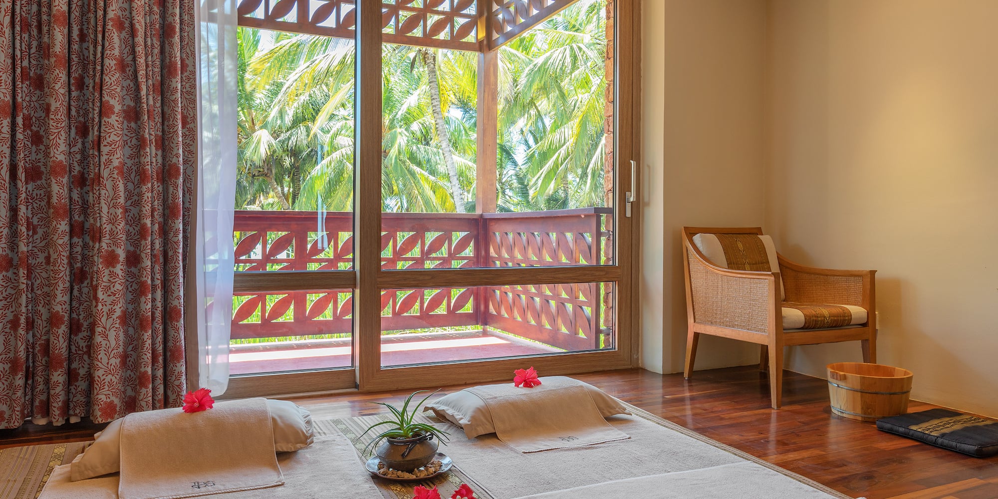 a room with a balcony and a chair and a bed