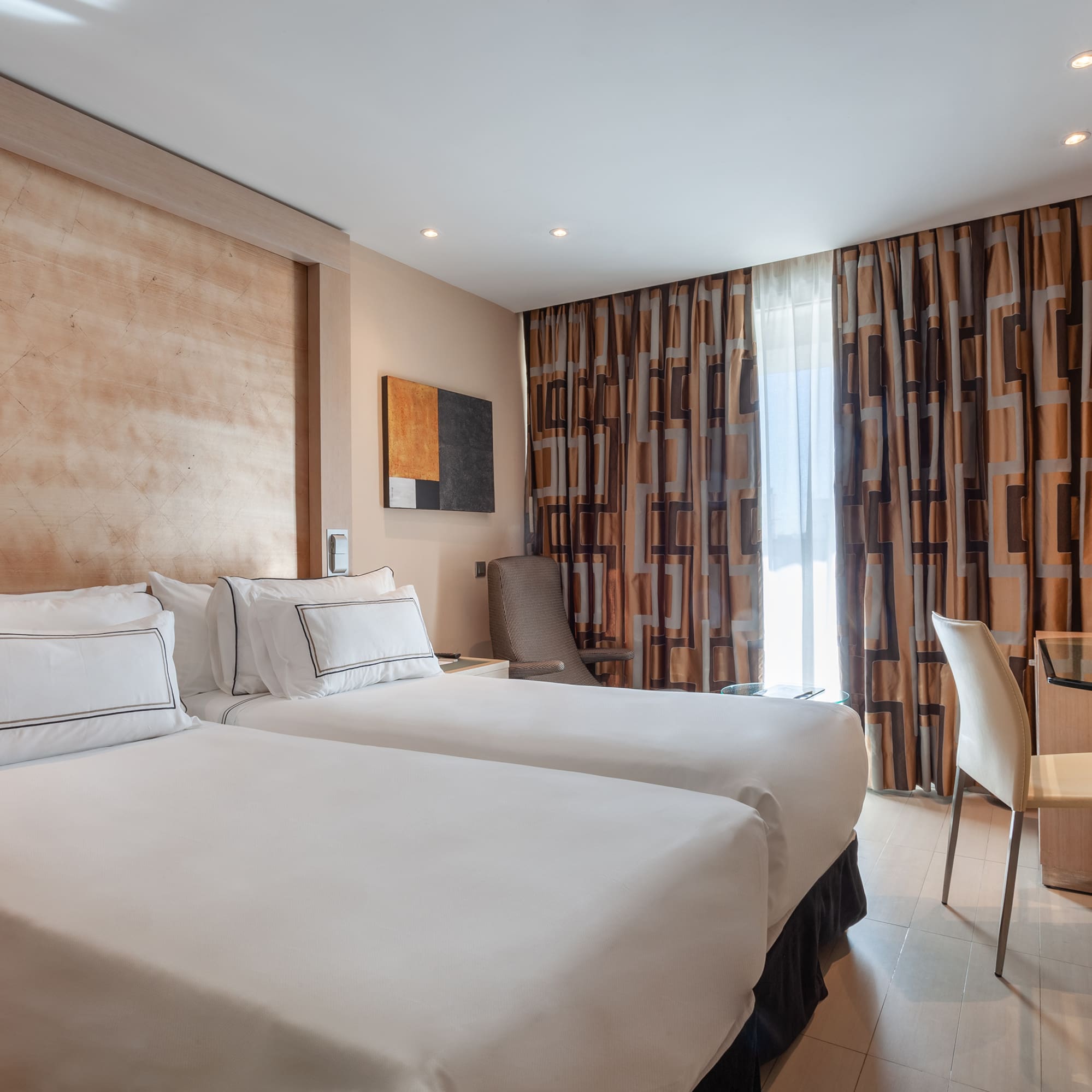 a room with two beds and a table